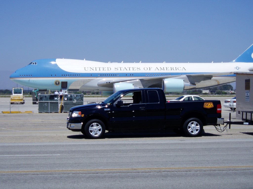A Black Gold Industries pickup truck parked in front of Air Force One