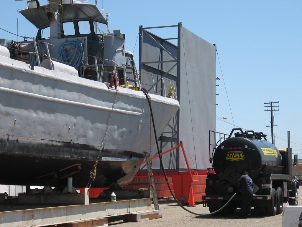 A Black Gold Industries tanker semi truck performing a bilge off-load