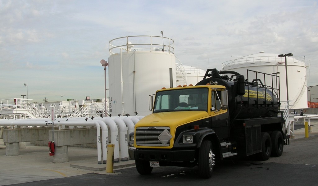 A Black Gold Industries vacuum truck parked in front of the LAX tank farm